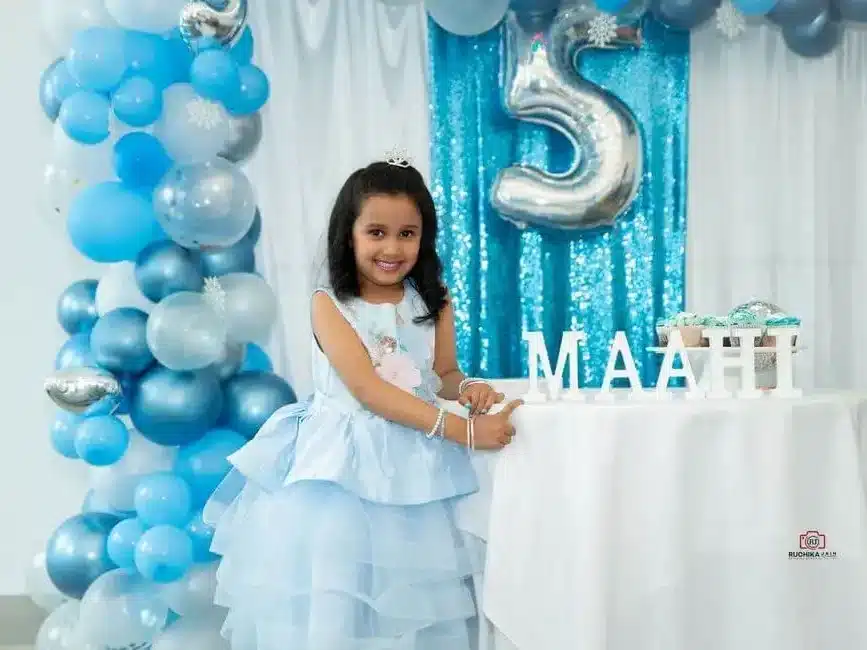 Small child celebrating birthday with cake.