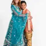 Mother and son in traditional attire smiling in a studio portrait by Ruchika Jain Photography
