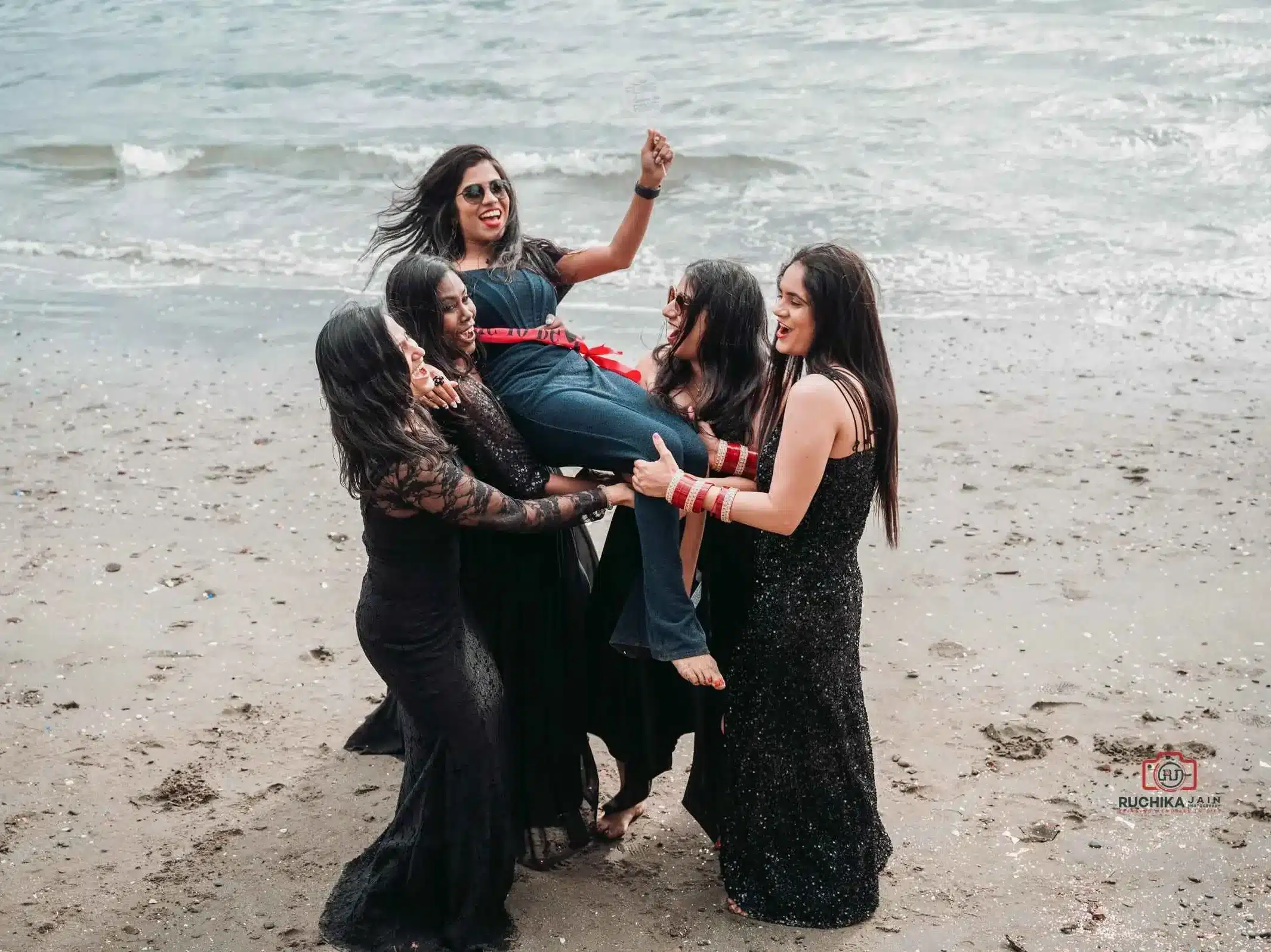 Beach Bachelorette Party Fun: A group of friends joyfully celebrating a bachelorette party on the beach, splashing water and creating wonderful memories