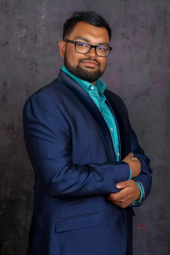 A professional headshot of a woman in business attire against a neutral background