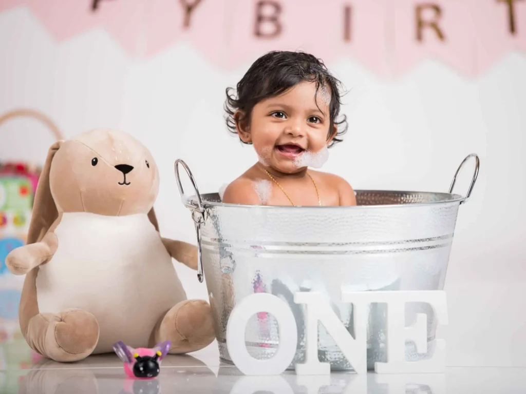 Cake smash session with a happy child enjoying the sugary treat