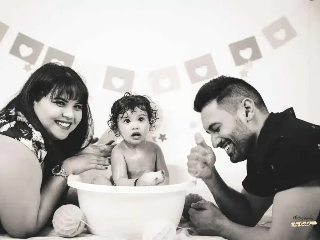 Toddler giggling while smashing cake in a photography session