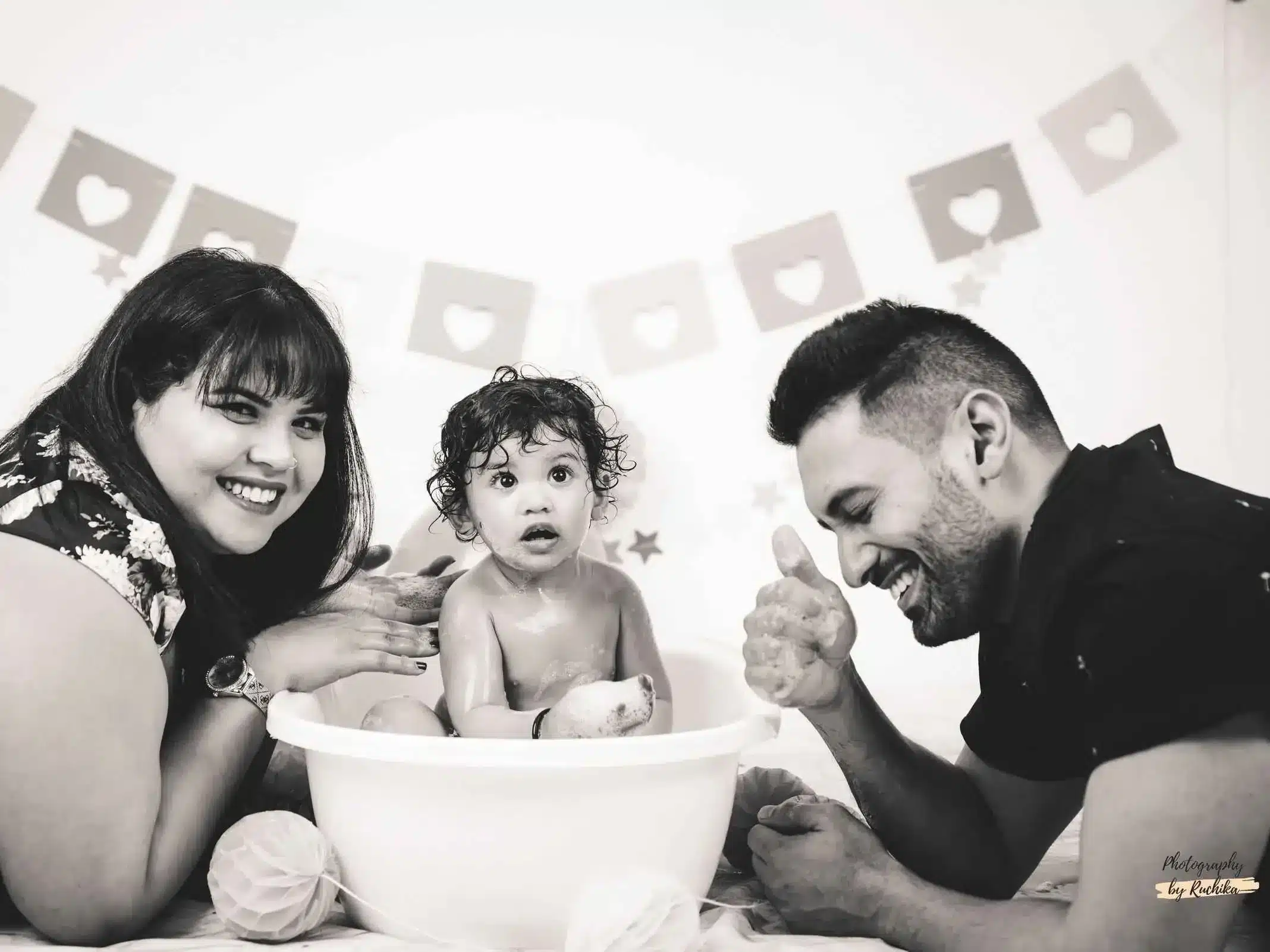 Toddler giggling while smashing cake in a photography session
