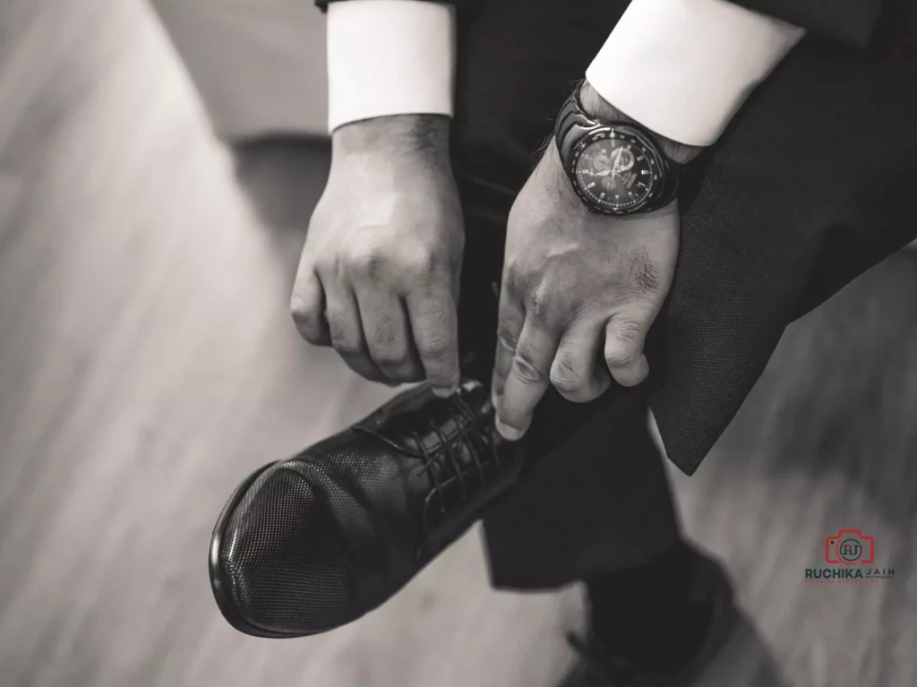 Groom getting ready, putting on wedding shoes and accessories - The Ultimate Wedding Guide