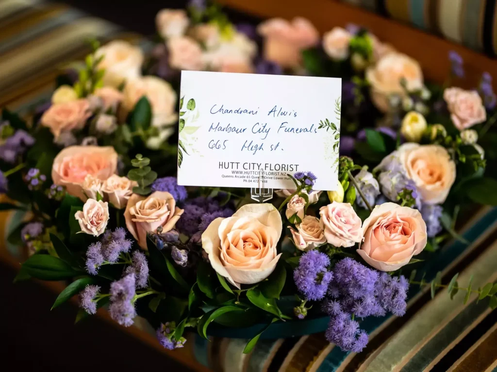 Memorial Tribute: A floral casket spray with a heartfelt card dedicated to the departed soul at a funeral