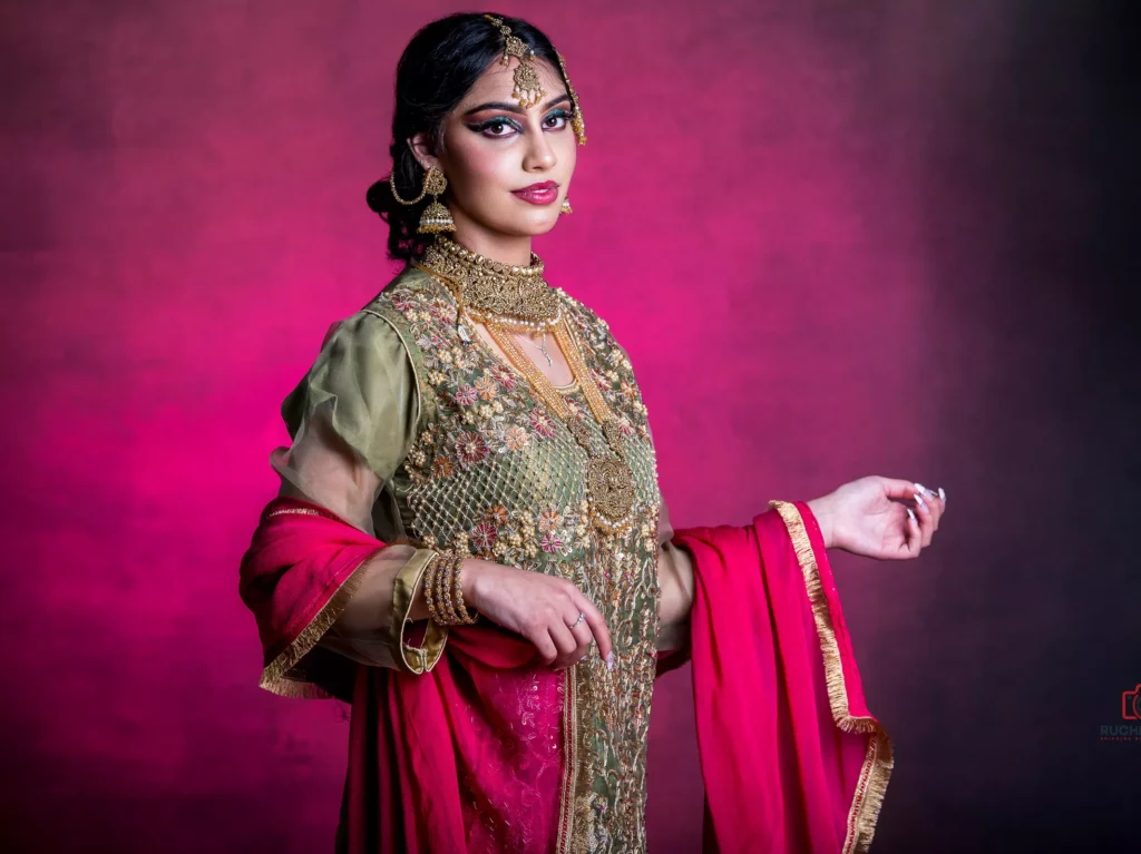 Elegant clothing photography by Ruchika Jain featuring a girl adorned with exquisite jewelry against a charming pinkish background