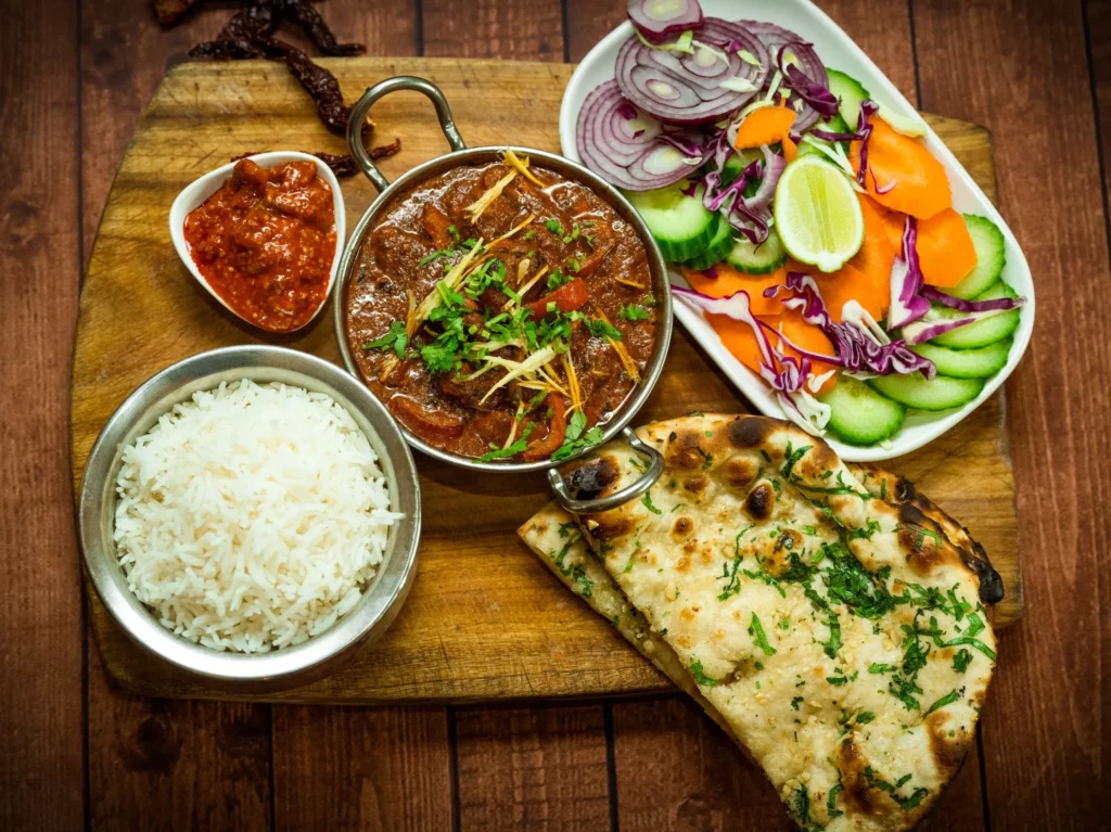 Mouthwatering desi dish with rice, salad, and spices, captured in exquisite commercial food photography.