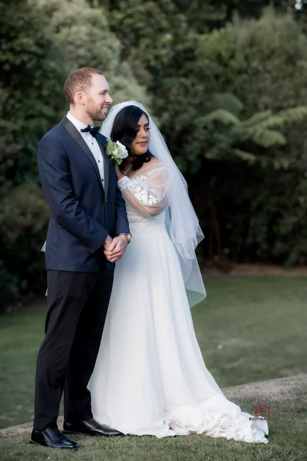 Bride placing her hand on groom's shoulder in outdoor wedding shoot - The Ultimate Wedding Guide