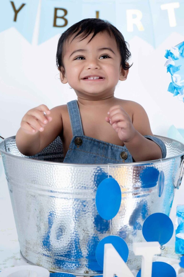 Energetic cake smash shoot highlighting the excitement of turning one