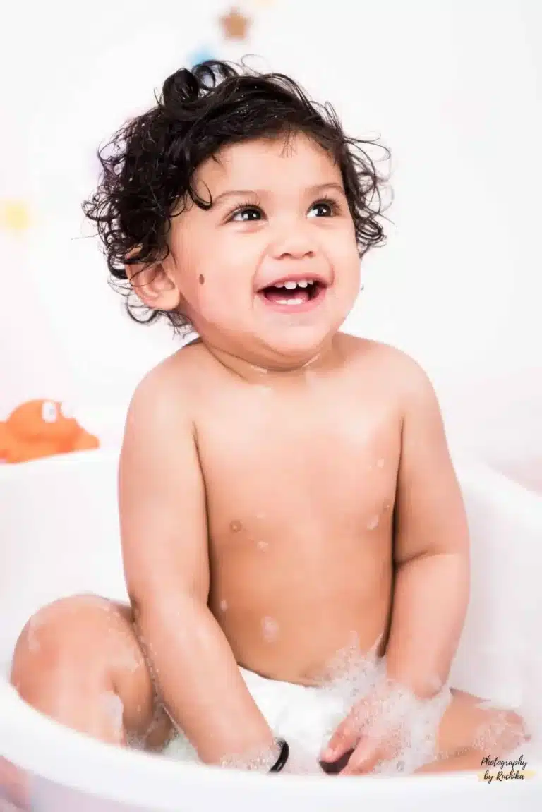 Adorable baby smashing cake with enthusiasm in a photography session