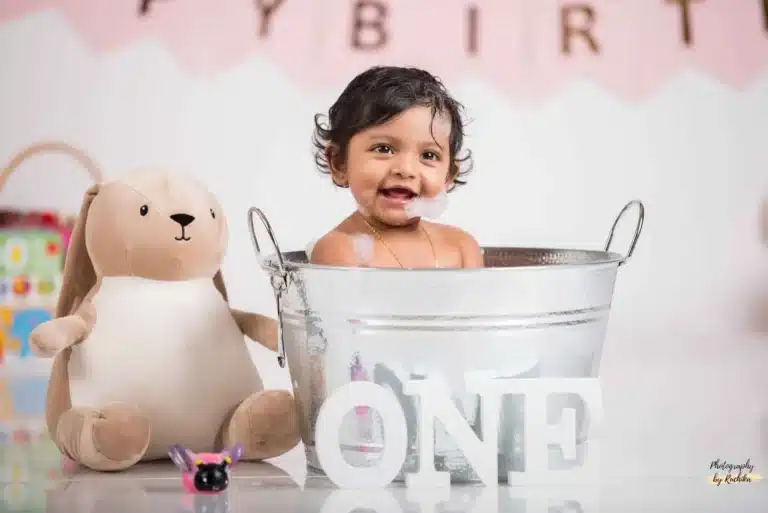 Happy child making a mess with cake during a cake smash shoot