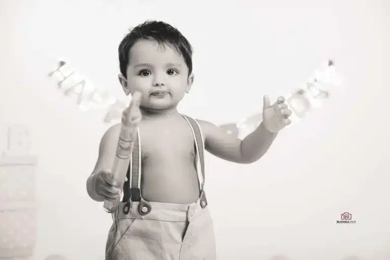 Playful cake smash session featuring a happy toddler and a delicious cake