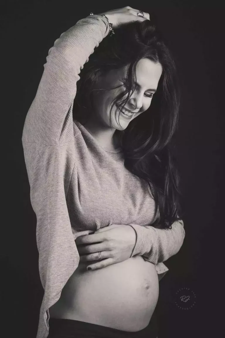 Radiant mom-to-be smiling in pregnancy photoshoot